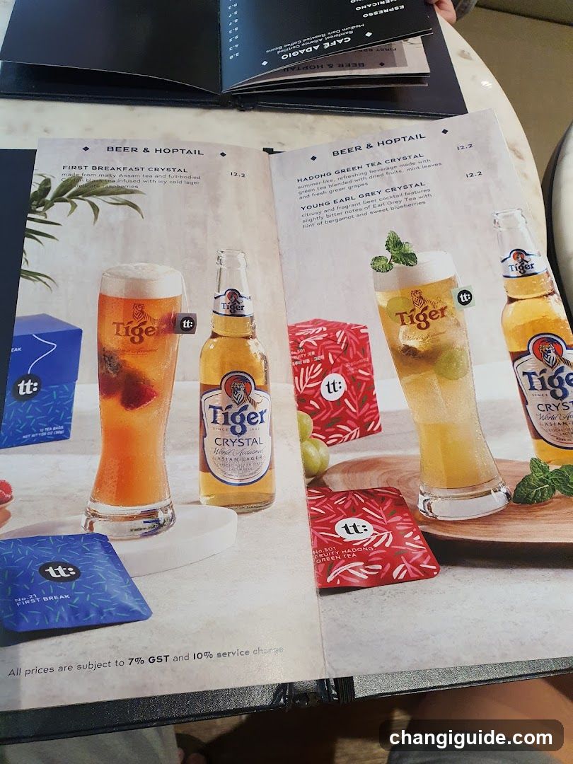 A printed menu page displaying Tiger Crystal beer-based cocktails, including First Breakfast Crystal and Hadong Green Tea Crystal, with prices listed in SGD.