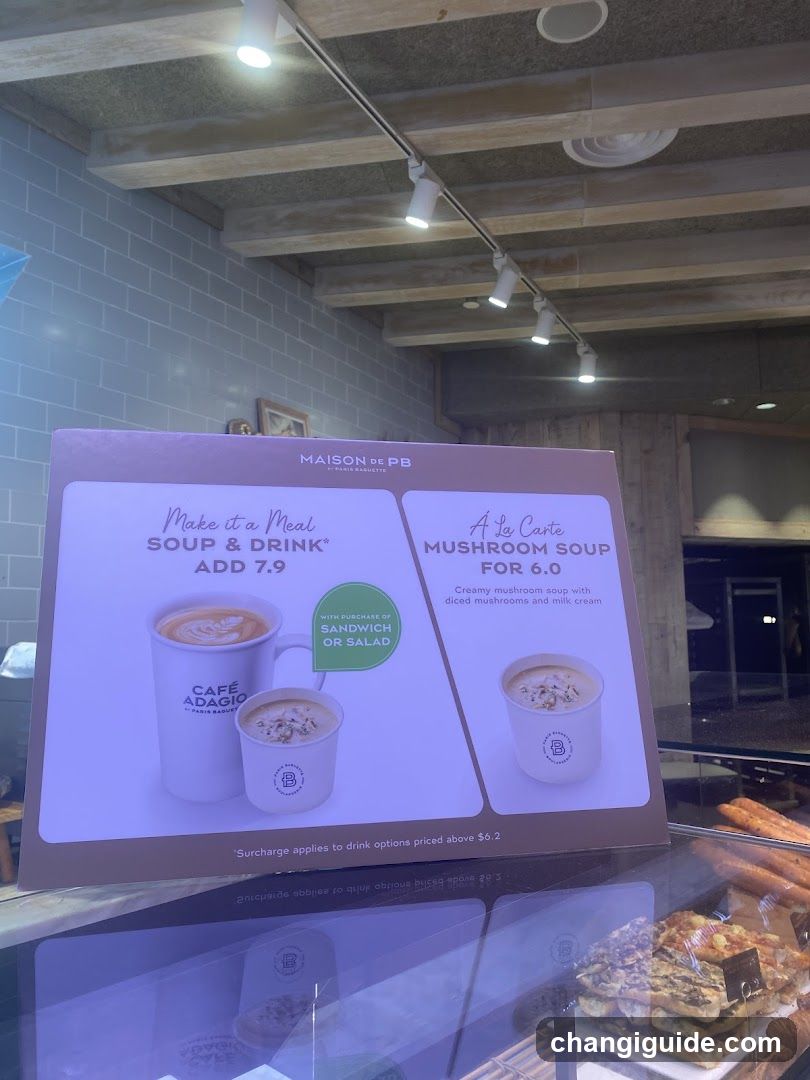 A promotional sign inside a cafe displaying soup and drink options, with prices listed as $7.9 and $6.0 respectively.