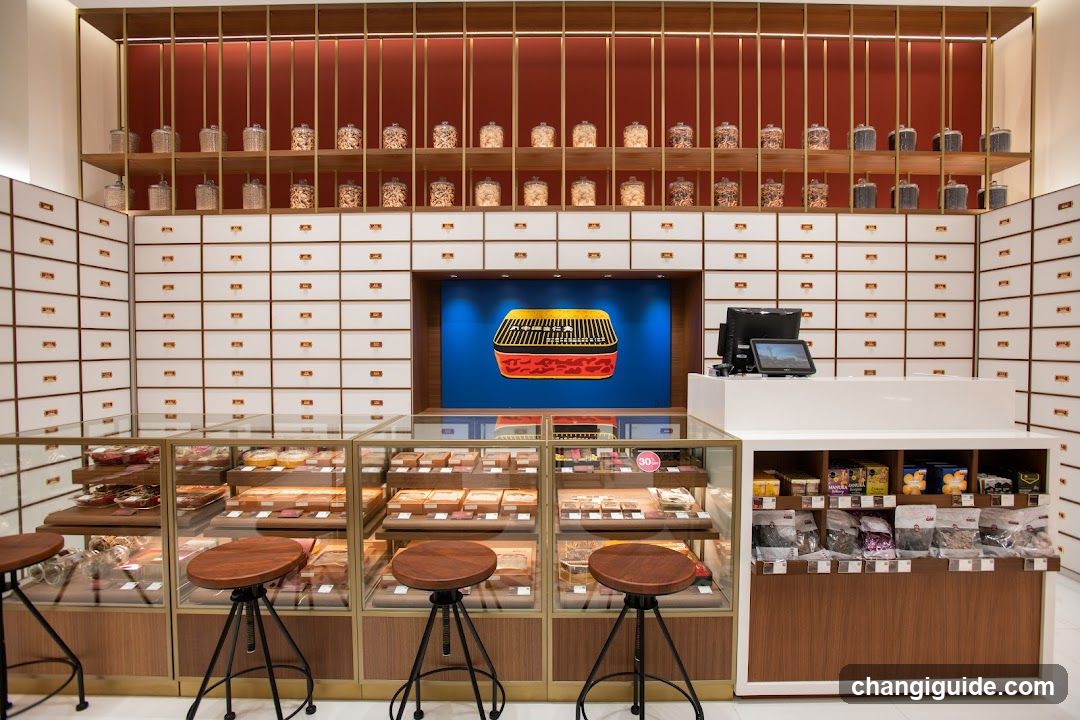 Interior of a traditional-style shop with glass display cases and wooden stools.