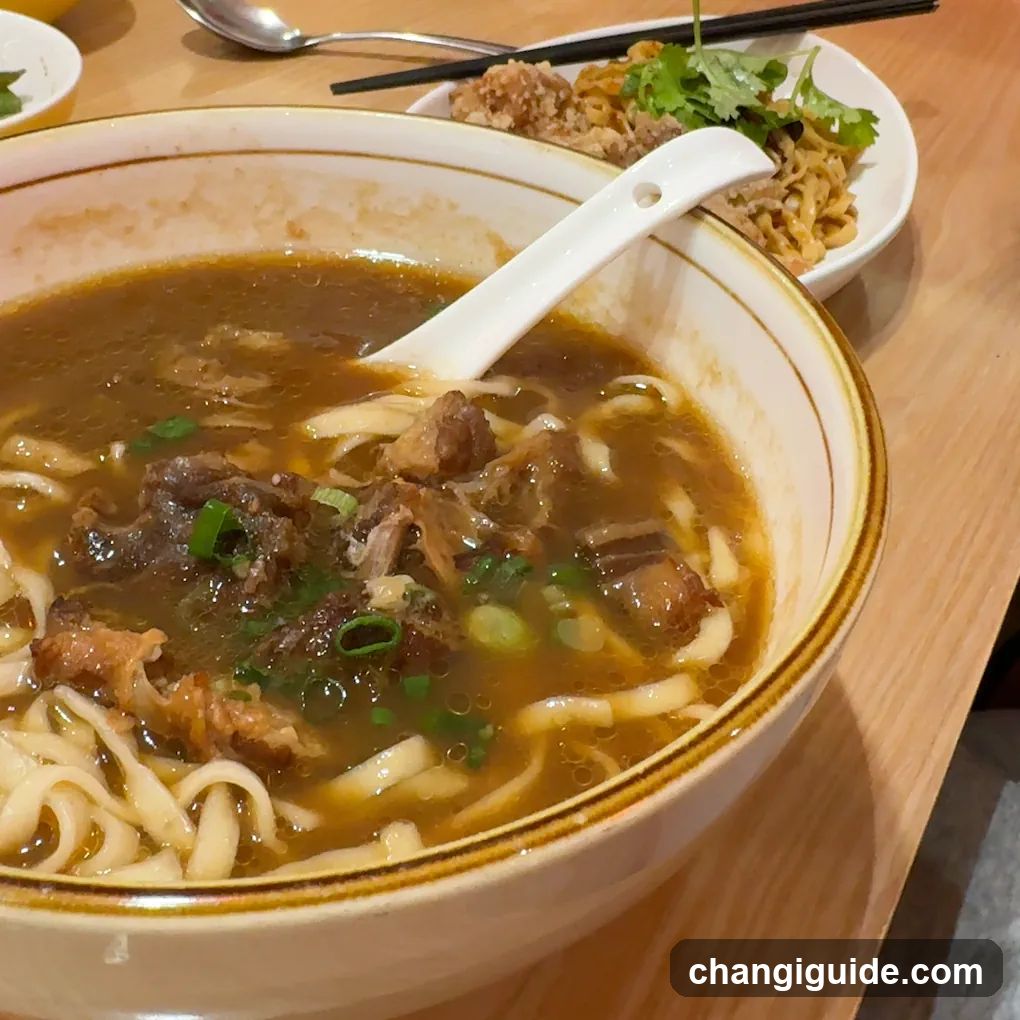 Bowl of Noodle Soup with Meat and Greens