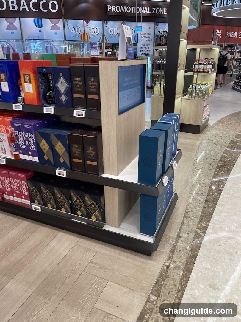 Interior view of a retail store featuring shelves stocked with various alcohol products, including Glenfiddich and other brands. Promotional signage is visible above the display area.