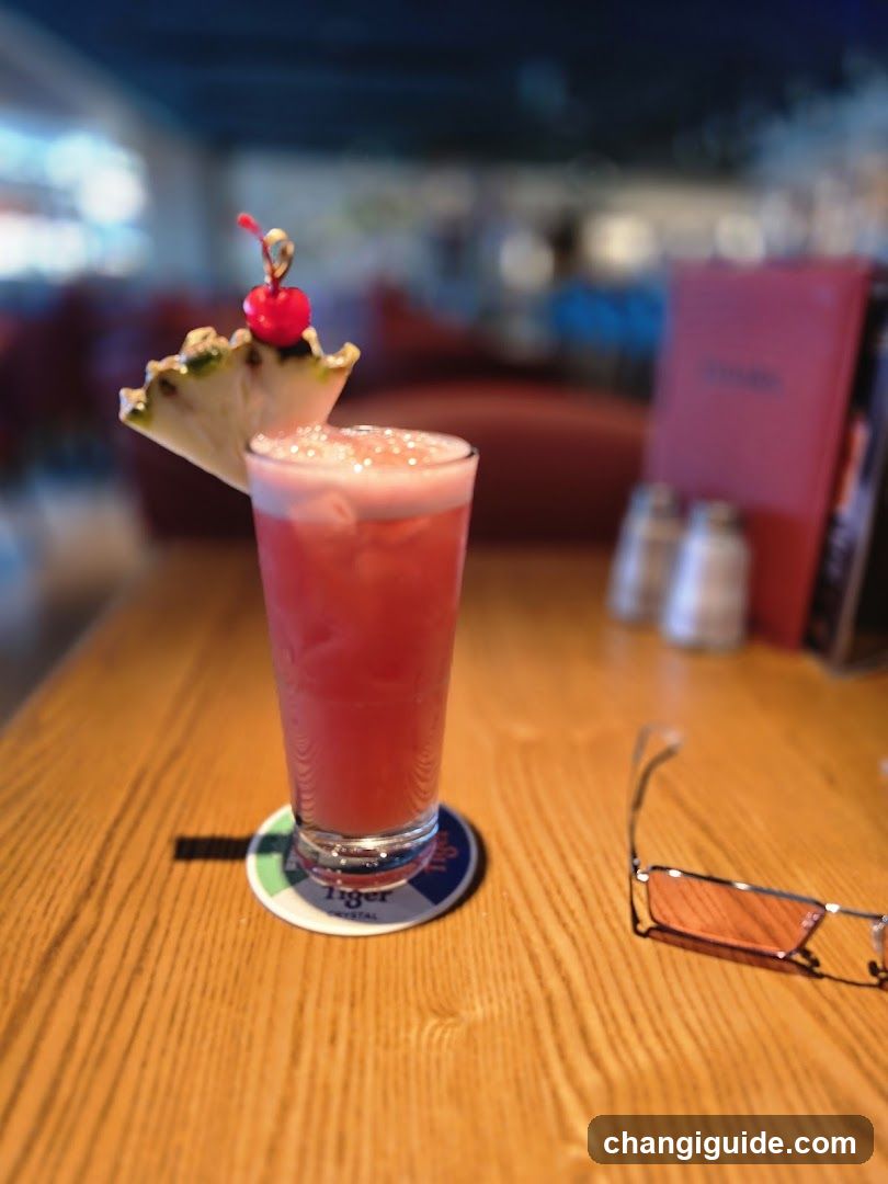 Pink Cocktail with Pineapple Garnish