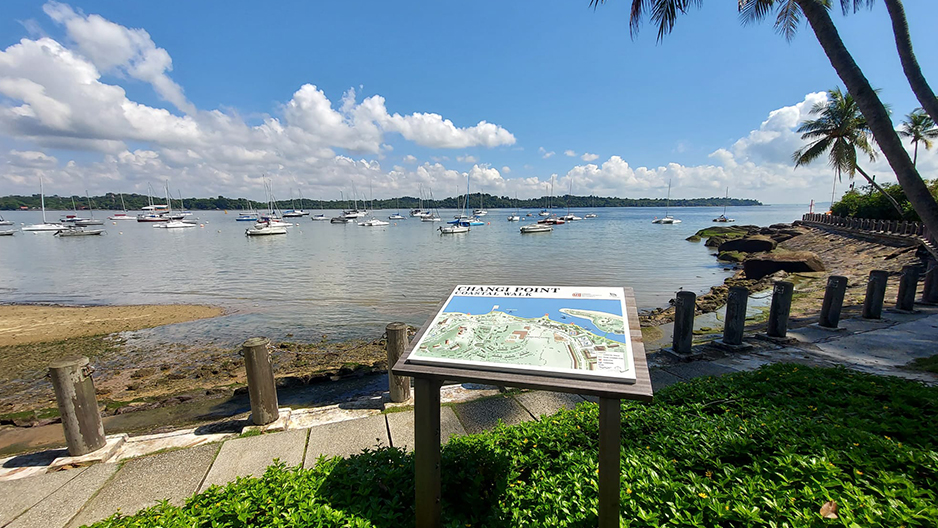 Changi Point Coastal Walk map sign with yachts at anchor off the beach