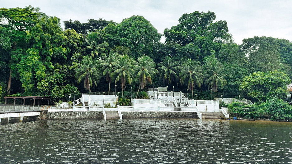 White clubhouse steps and terraces on the Changi Point shoreline, seen from the water