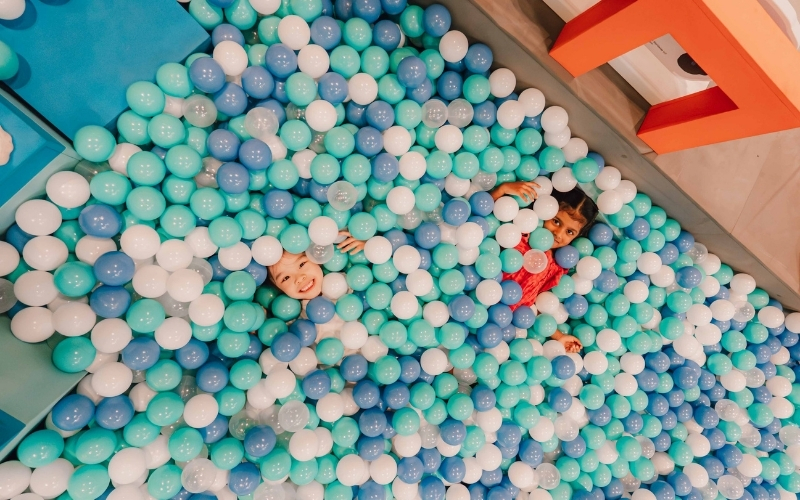 Children playing in the Peanuts ball pit at Changi Airport