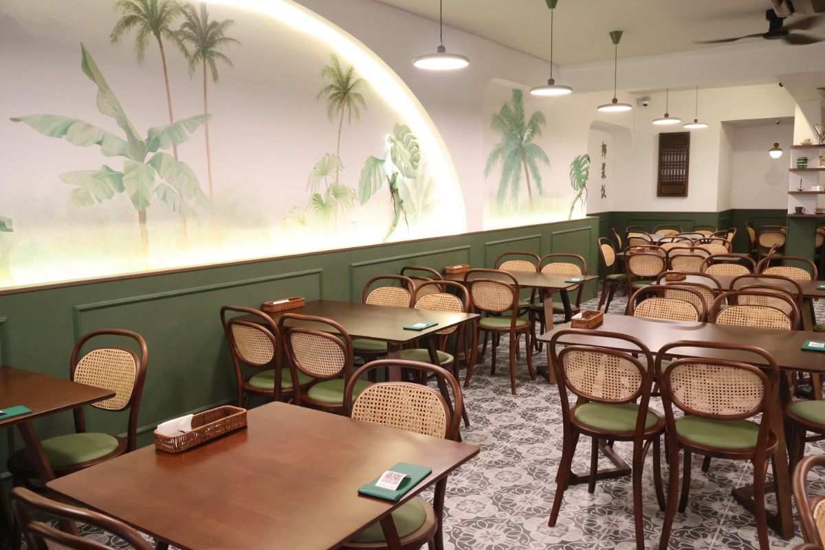 Wild Coco tropical interior with rattan chairs and wall art at Jewel Changi Airport